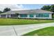 A well-maintained building with large glass windows and manicured landscaping at 334 Melrose Ct, Venice, FL 34292