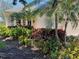 Well-maintained front yard with lush landscaping, palm trees, and mulch, adding to the home's curb appeal at 334 Melrose Ct, Venice, FL 34292