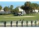 Picturesque golf course view featuring lush green fairways, palm trees, and waterfront at 334 Melrose Ct, Venice, FL 34292