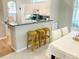 Open-concept kitchen with a breakfast bar, adjacent dining area, and modern features for comfortable living at 334 Melrose Ct, Venice, FL 34292