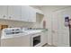 Functional laundry room with white washer, dryer, cabinets, and utility sink at 334 Melrose Ct, Venice, FL 34292