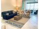 Comfortable living room area with plush seating, neutral color scheme, and access to screened lanai at 334 Melrose Ct, Venice, FL 34292