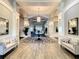 Elegant lobby with a round center table, decorative carpet, and mirrors creating a welcoming space at 334 Melrose Ct, Venice, FL 34292