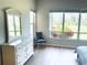 Spacious main bedroom featuring large windows, a dresser, and natural light at 334 Melrose Ct, Venice, FL 34292