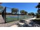 Nice pickleball court with green and blue surface surrounded by a black chain link fence at 413 Rio Terra, Venice, FL 34285