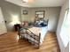 Bedroom with a bed, chair, and wood-look floors at 257 Palm Harbor Dr, North Port, FL 34287