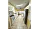 Bright kitchen with white appliances and yellow cabinets at 257 Palm Harbor Dr, North Port, FL 34287