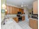 Bright kitchen with wood cabinets, stainless steel appliances, and tile flooring at 688 Back Nine Dr, Venice, FL 34285