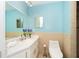 Clean bathroom with light blue walls and modern toilet at 3460 Shamrock Dr, Venice, FL 34293