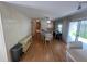 Spacious dining area with wood-look floors and a view into the kitchen at 923 Cortina Blvd, Venice, FL 34285