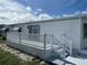 White deck with railing, steps, and access to the home at 923 Cortina Blvd, Venice, FL 34285