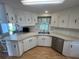Bright kitchen features ample counter space, stainless steel appliances, and white cabinets at 923 Cortina Blvd, Venice, FL 34285