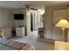 Bedroom with TV, dresser, and bathroom access at 923 Cortina Blvd, Venice, FL 34285
