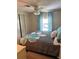 Spacious bedroom with large window, ceiling fan, and ample closet space at 923 Cortina Blvd, Venice, FL 34285