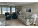 Living room with floral sofa, two green recliners, and ceiling fan at 923 Cortina Blvd, Venice, FL 34285