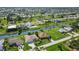 Expansive aerial view of a charming community with waterfront homes and lush greenery at 233 Fairway Rd, Rotonda West, FL 33947