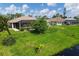 Aerial view of fenced backyard with lush lawn and screened in patio and pool at 233 Fairway Rd, Rotonda West, FL 33947