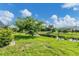Backyard view of a canal with a fence and a lush green lawn at 233 Fairway Rd, Rotonda West, FL 33947