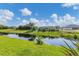 The home features a private canal with grass and relaxing views at 233 Fairway Rd, Rotonda West, FL 33947