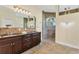Bathroom boasts double vanity with granite counters and large walk-in shower at 233 Fairway Rd, Rotonda West, FL 33947