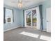 Bedroom features a ceiling fan and sliding glass doors offering access to a screened pool area at 233 Fairway Rd, Rotonda West, FL 33947