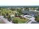 Aerial view of clubhouse surrounded by palm trees, parking, and golf course showcasing the community amenities at 233 Fairway Rd, Rotonda West, FL 33947