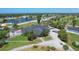 Aerial view of clubhouse, golf course, parking and boat harbor featuring palm trees and professional landscaping at 233 Fairway Rd, Rotonda West, FL 33947
