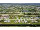 Aerial view of a community with homes near golf courses, waterways and landscaped lawns to enhance value at 233 Fairway Rd, Rotonda West, FL 33947