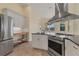 Modern kitchen with stainless steel appliances, granite countertops, island, and ample cabinet space at 233 Fairway Rd, Rotonda West, FL 33947