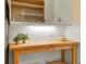Close up of the kitchen counter with storage underneath, white subway tile, and light wood countertop at 233 Fairway Rd, Rotonda West, FL 33947