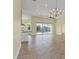 Spacious living area with tile floors, kitchen island, and sliding glass doors to outdoor pool area at 233 Fairway Rd, Rotonda West, FL 33947
