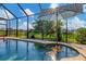 Sparkling pool features a built-in table with umbrella for enjoying drinks in the sun at 233 Fairway Rd, Rotonda West, FL 33947