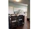 The kitchen has bright white cabinets, stainless steel appliances, and wood flooring at 4240 Central Sarasota Pkwy # 616, Sarasota, FL 34238
