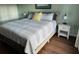 Serene main bedroom featuring light-colored walls, wood floors and two nightstands at 4240 Central Sarasota Pkwy # 616, Sarasota, FL 34238