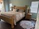 Cozy main bedroom with a wooden bed frame, soft lighting and exterior views at 4240 Central Sarasota Pkwy # 616, Sarasota, FL 34238