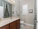 Well-lit bathroom with shower and toilet at 10385 Crooked Creek Dr, Venice, FL 34293