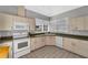 Well-equipped community kitchen with white appliances at 1188 Harbor Town Way, Venice, FL 34292