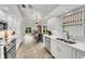 Modern kitchen with white cabinets, stainless steel appliances, and tile flooring at 1188 Harbor Town Way, Venice, FL 34292