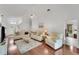 Bright living room with hardwood floors, plush seating, and ample natural light at 1188 Harbor Town Way, Venice, FL 34292