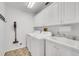 Bright laundry room with washer, dryer, and ample cabinet space at 1188 Harbor Town Way, Venice, FL 34292