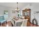 Bright dining room with hardwood floors, a chandelier, and a wine rack at 1188 Harbor Town Way, Venice, FL 34292