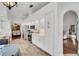 Modern kitchen with white cabinets, stainless steel appliances and a view into the living room at 1188 Harbor Town Way, Venice, FL 34292