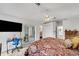 Main bedroom with king bed and access to bathroom and patio at 1188 Harbor Town Way, Venice, FL 34292