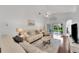 Relaxing living room featuring hardwood floors, neutral furniture and access to a patio at 1188 Harbor Town Way, Venice, FL 34292