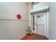 Front entry with terracotta tile flooring, potted plants, and a red flower decoration at 1188 Harbor Town Way, Venice, FL 34292