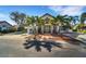 Community clubhouse with palm trees and inviting entrance at 1188 Harbor Town Way, Venice, FL 34292