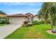 Single-story home with a well-maintained lawn at 1188 Harbor Town Way, Venice, FL 34292