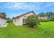 View of house exterior showcasing landscaping and backyard at 1188 Harbor Town Way, Venice, FL 34292