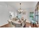 Elegant dining room with hardwood floors, a chandelier, and a large hutch at 1188 Harbor Town Way, Venice, FL 34292