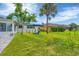Large backyard with grassy lawn and seating area under umbrella at 8509 La Boca Ave, North Port, FL 34287
